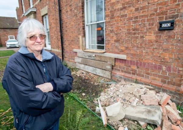 Lucky escape: Janet O'Regan in front of her boarded up house front. Picture: John Aron.