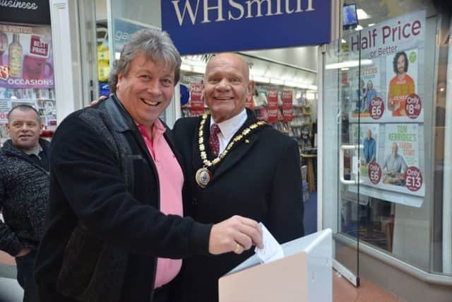 Chris Pain posts his views, watched by Mayor of Skegness Coun Sid Dennis. Photo: Barry Wilkinson. ANL-190114-104243001