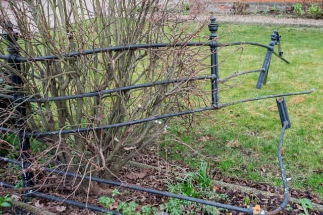 The mangled railings between her front garden and a neighbour's property. Picture: John Aron.