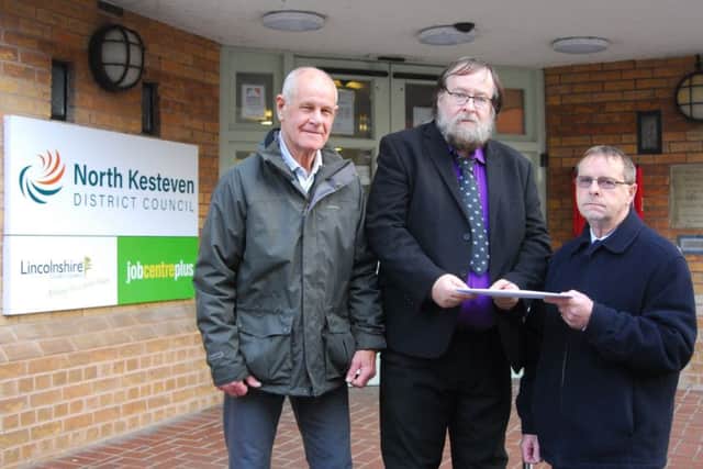 Sleaford Indoor Bowls Club representatives hand over their petition to North Kesteven District Councillor David Suiter. EMN-190115-091230001