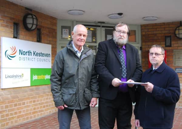 Sleaford Indoor Bowls Club representatives hand over their petition to North Kesteven District Councillor David Suiter. EMN-190115-091230001
