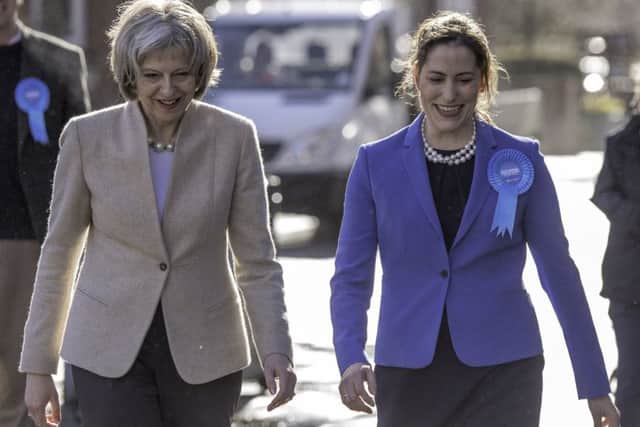 Theresa May and Victoria Atkins EMN-150104-120719001