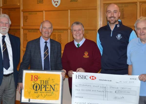 Presenting the donation. From left - Lincolnshire Freemasons Golf Association chairman Terry Little, raffle winner Ed Walters,
Nick Musson, Junior Organiser at Sleaford Golf Club Dougie Coote and Association Secretary Mick Wright. EMN-190118-135823001