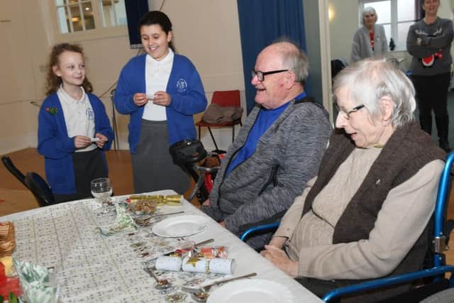Youngesters from Spilsby Christian Fellowship helped entertain guests at the Spilsby Standard Chrismas Community Lunch. Pictured (from left) are Spilsby primary school pupils Amber Garrard 10 and Leah Camm with Geoffrey and Elizabeth Brawn. ANL-190116-135052001