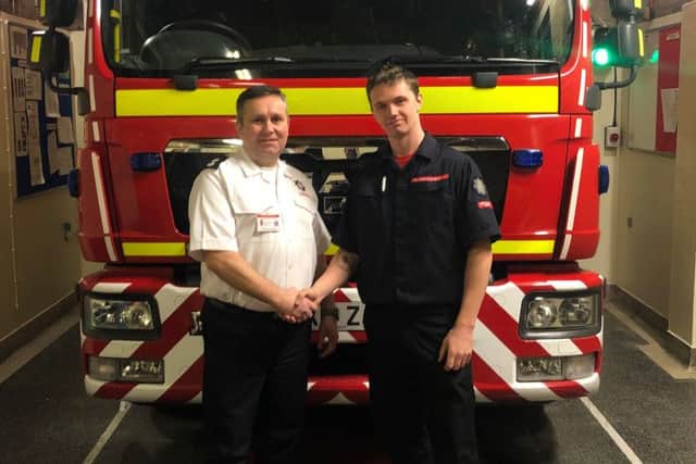 Rob Parker being welcomed to the Binbrook firecrew by watch manager Anthony Snowden EMN-190122-064641001
