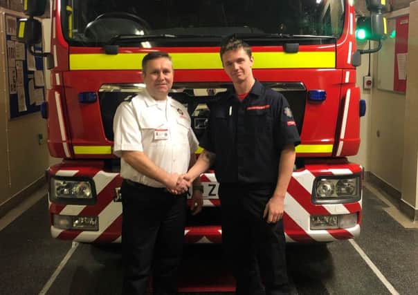 Rob Parker being welcomed to the Binbrook firecrew by watch manager Anthony Snowden EMN-190122-064641001