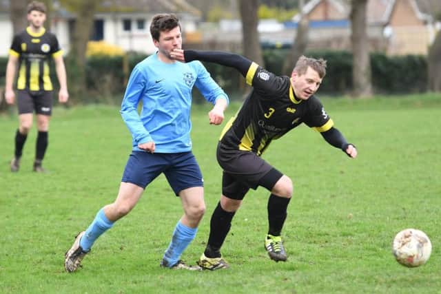 Friskney (blue) v Wyberton (yellow). Jeremy Brown (blue), Edgar Geglis (yellow).