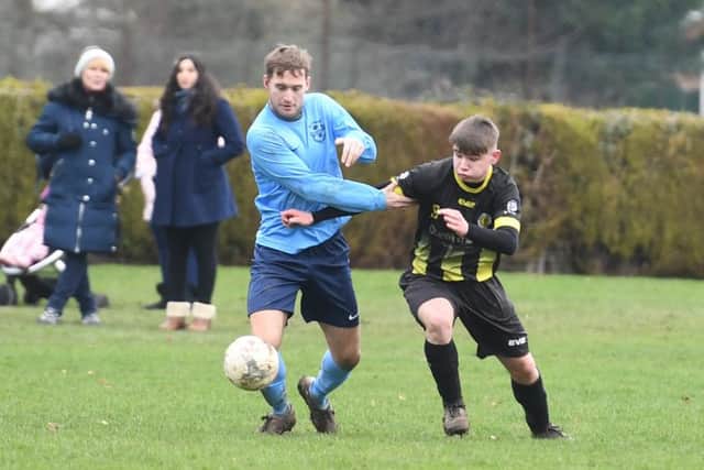 Friskney (blue) v Wyberton (yellow). Jobe Stainton (blue), Callum Edwards (yellow).