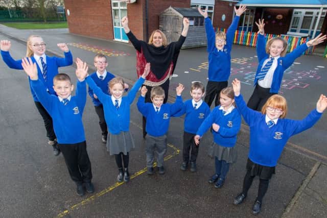 Janette Davey, Headteacher with pupils jumping for joy. EMN-190121-125933001