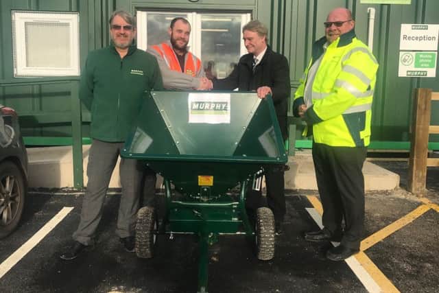 Coun Graham Fisher (second right) is presented with the new gritter by (from left) Mark Kay. Murphy project director, Scott Marsden, Murphy project manager and Martin Knagg, Triton Knoll package manager. ANL-190117-154231001