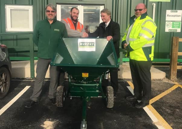 Coun Graham Fisher (second right) is presented with the new gritter by (from left) Mark Kay. Murphy project director, Scott Marsden, Murphy project manager and Martin Knagg, Triton Knoll package manager. ANL-190117-154231001