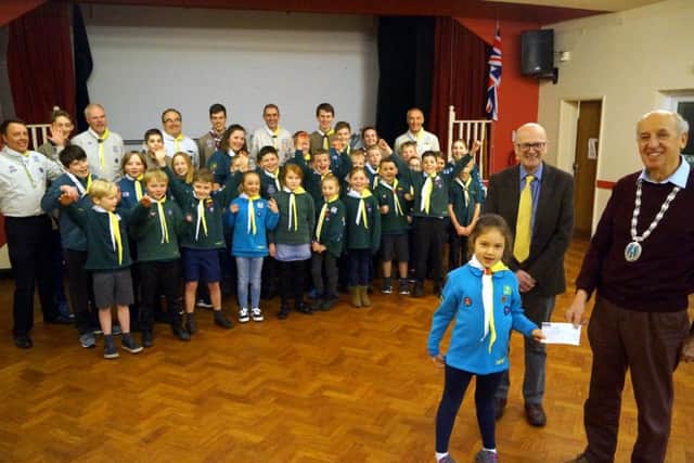 Caistor Mayor Alan Somerscales and Coun Steve Gaughan present the cheque to seven-year-old Sunny, who is moving up from Beavers to Cubs EMN-190129-062819001