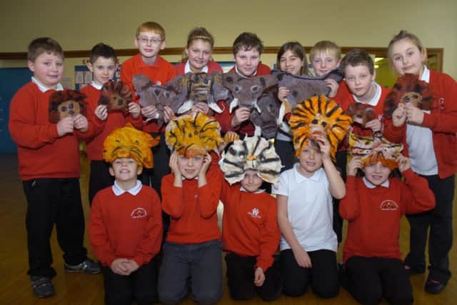 Year Six children with their felt masks.
