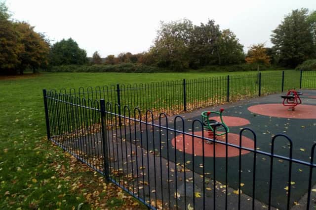 The site of the proposed recreation park is in the background. In the foreground is the childrens playground