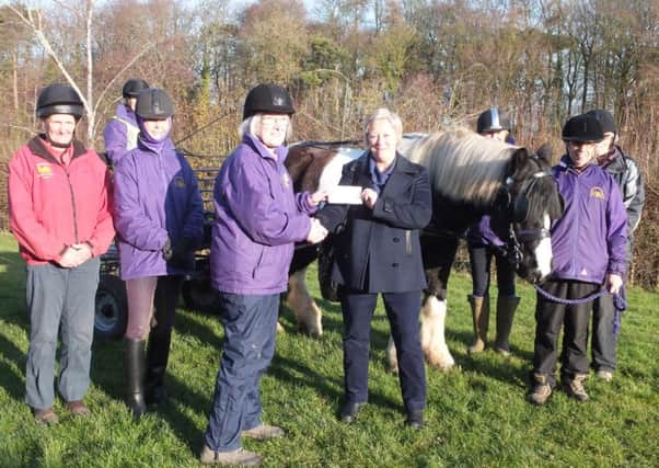 Lesley Dover, chairman of Churches Together in Louth and District,presents the cheque to the Lincolnshire Wolds Riding for the Disabled Association.