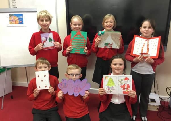 Children from Chestnut Street's 5GR class with cards they were sent from their partner schools in Lebanon.