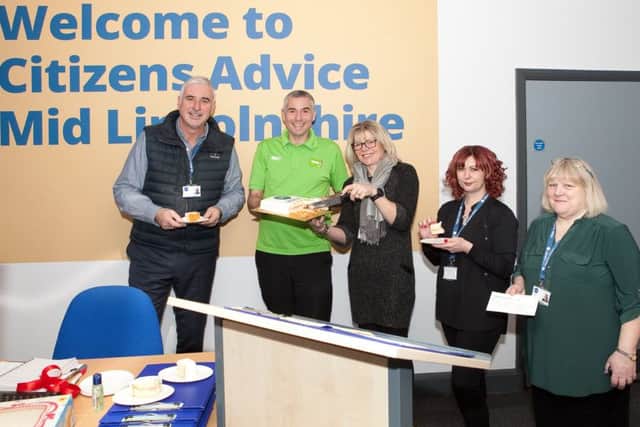 Sharing a cake decorated with the sum awarded to the charity, Citizen Advices Kingsley Taylor, Carolyn Whiley, Louise Welles, and Vicki Langley, with Asdas Stephen Bromby.