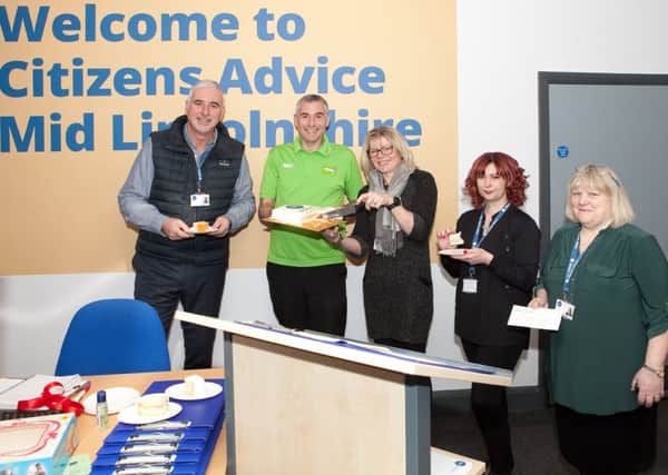 Sharing a cake decorated with the sum awarded to the charity, Citizen Advices Kingsley Taylor, Carolyn Whiley, Louise Welles, and Vicki Langley, with Asdas Stephen Bromby.