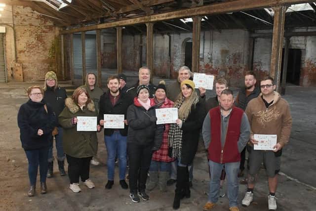 Sam Beeson and Linda Baxter with trustees and local trades people in side the warehouse. EMN-190402-091452001