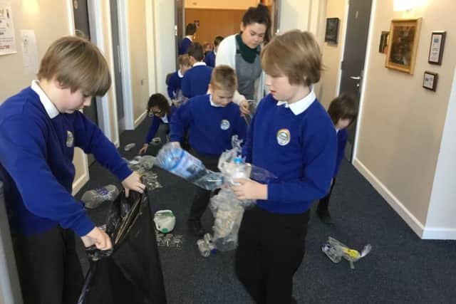 Pu[ils at Friskney All Saints (C of E) Primary School picking up plastic dumped in a corridor. ANL-190402-103642001