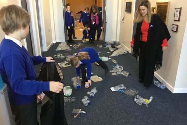 Pu[ils at Friskney All Saints (C of E) Primary School picking up plastic dumped in a school corridor. The area had been cordoned off by PCSO Jane Richardson. ANL-190402-103723001
