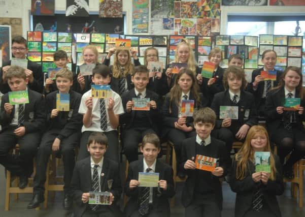 Some of the pupils who have created a postcard showing their favourite thing about Market Rasen EMN-190502-092340001