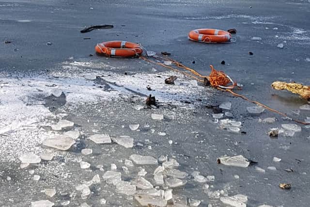 Life saving rubber rings were thrown onto the frozen pond. Picture: Jonathan Schofield. EMN-190402-152840001