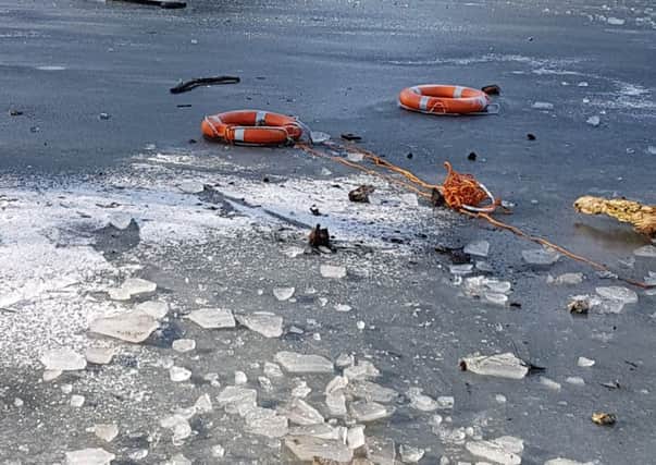 Life saving rubber rings were thrown onto the frozen pond. Picture: Jonathan Schofield. EMN-190402-152840001