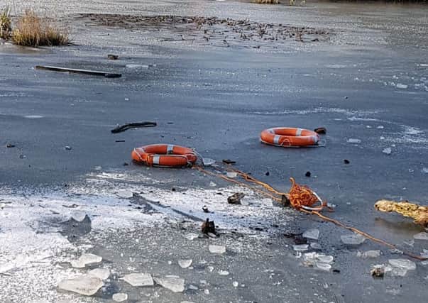 Life saving rubber rings were thrown onto the frozen pond. Picture: Jonathan Schofield. EMN-190402-152840001