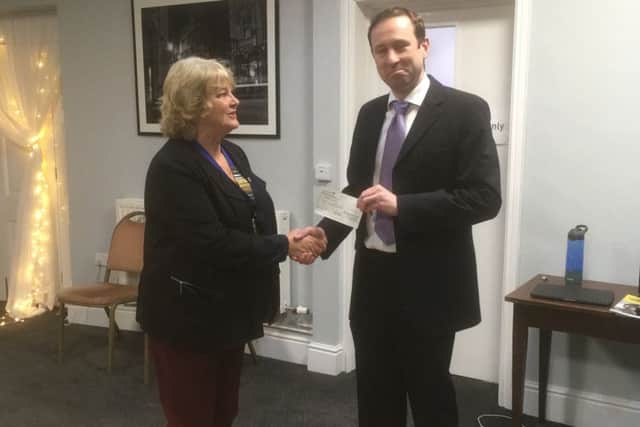 Sleaford Lions president Sue La Roche presents a cheque to Squadron Leader Mike Child, former Red Arrow pilot. EMN-190702-141301001