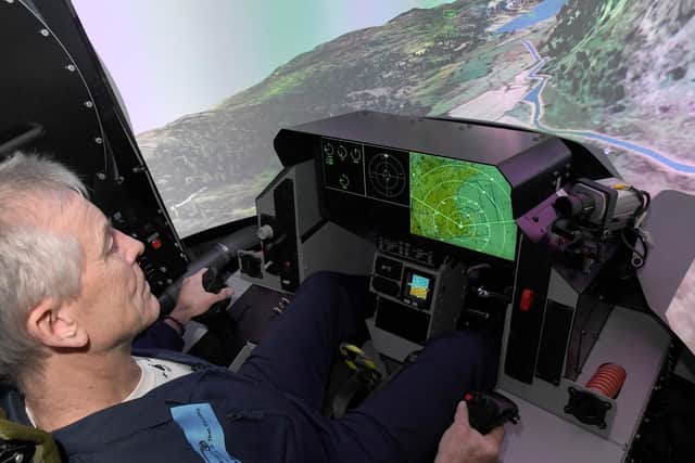 Training manager David Bolsover demonstrates the cockpit view inside the High G simulator.