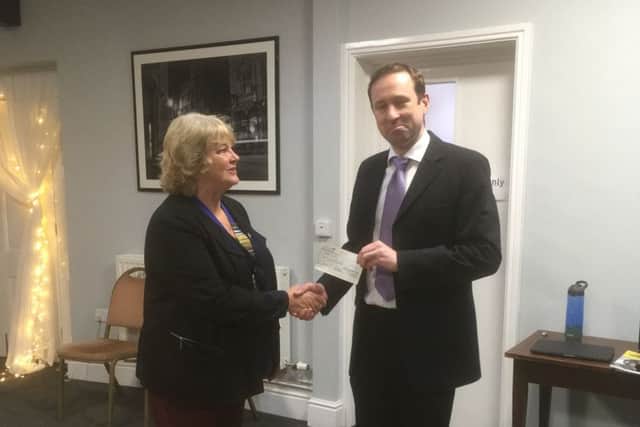 Sleaford Lions president Sue La Roche presents a cheque to Squadron Leader Mike Child, former Red Arrow pilot. EMN-190702-141301001