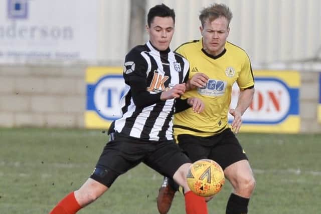 Two-goal hero Reece Moody (stripes) saw Brigg through against Wyberton in the county cup semi-final PICTURE: Nigel West