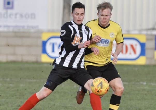 Two-goal hero Reece Moody (stripes) saw Brigg through against Wyberton in the county cup semi-final PICTURE: Nigel West