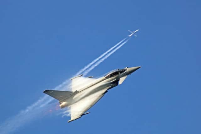 Perfect timing as the Typhoon climbs and crosses the vapour trail of a passing jet. EMN-190218-124038001