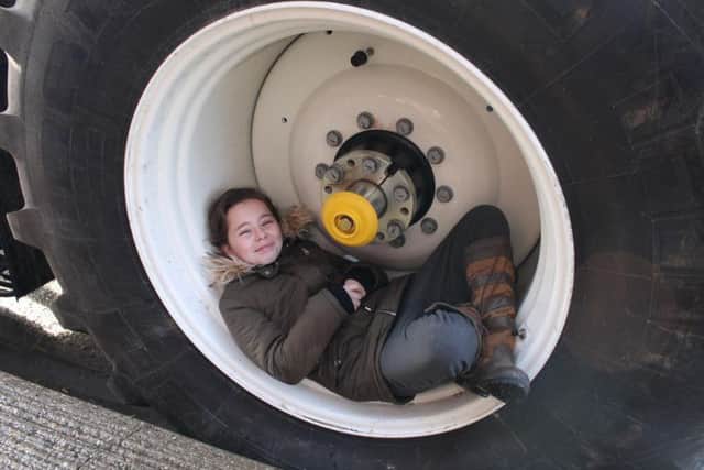 One pupil made herself at home in one of the tractor wheels!