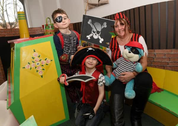 Pirate themed crafts and stories at Sleaford Library. Cultural Services advisor Helen Keeping with L-R Jenson Middleton 6 and Dexter Pell 5. EMN-190226-094318001