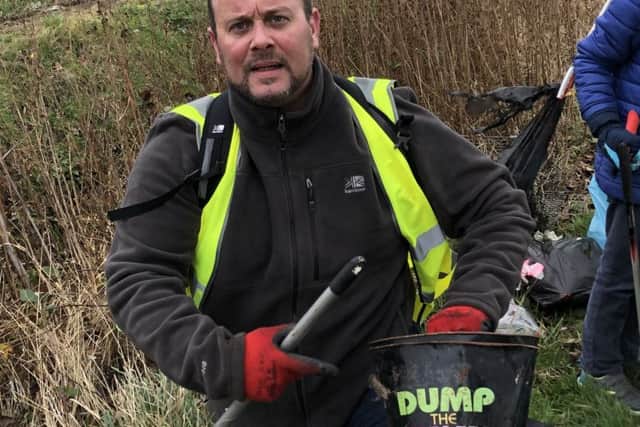 Mark Douglas collecting flytipped rubbish. EMN-190226-120536001