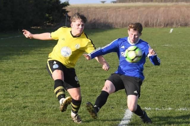 Mareham (blue) v Wyberton (yellow). Connor Treston (blue), Arron Bailey (yellow)