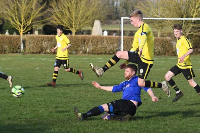 Mareham (blue) v Wyberton (yellow). Adam Eyre (blue), Reece Martin (yellow)