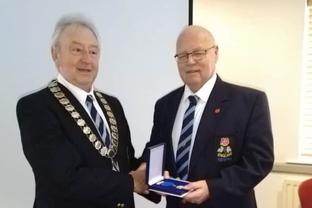 Mick, right, collects his award from England Tug of War Association president Mike Callaghan.