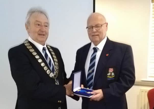 Mick, right, collects his award from England Tug of War Association president Mike Callaghan.