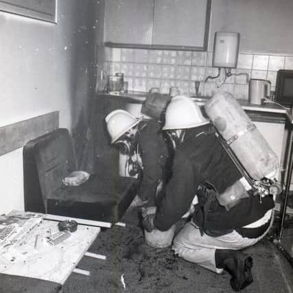 Fire crews inspect the scene of the outbreak in 1984.