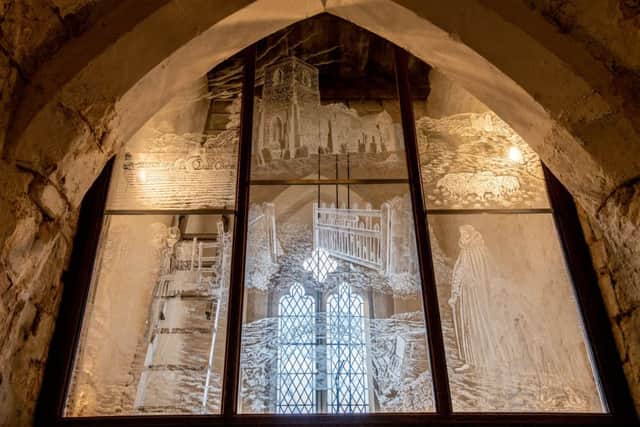 The unique engraved window within the church.