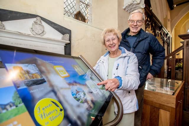 Penny and Roger Staniforth try out the interactive touch screen.