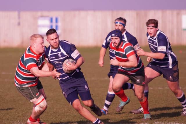 Sam Hughes is pictured carrying the ball, supported by Nigel Lane and Jake Blanchard. Photo: Mark Cleaver.