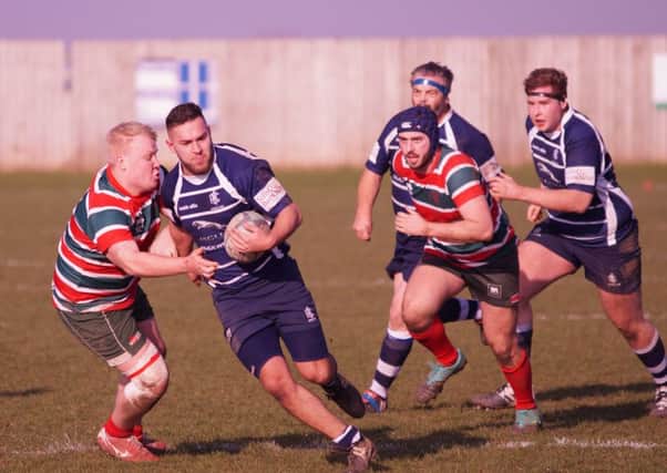 Sam Hughes is pictured carrying the ball, supported by Nigel Lane and Jake Blanchard. Photo: Mark Cleaver.