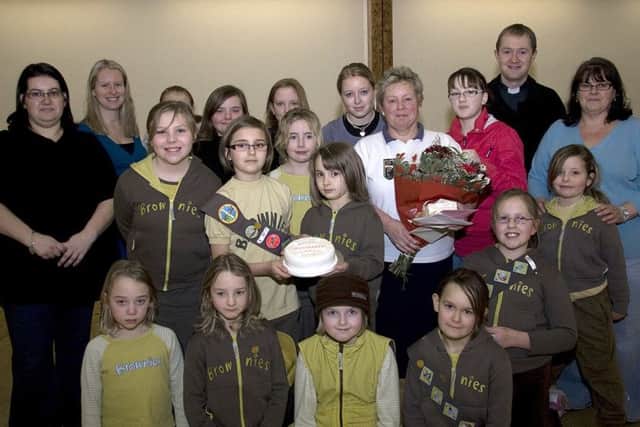 A scene from the surprise party for Joy Smith (with flowers) 10 years ago.