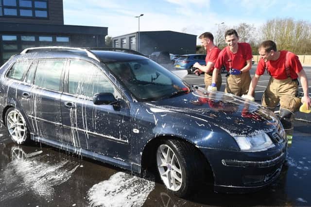Charity car wash at Sleaford Fire Station. L-R Crew manager Colin Calam, Crew manager Marc Gardener, Firefighter James Blythe. EMN-190403-102015001