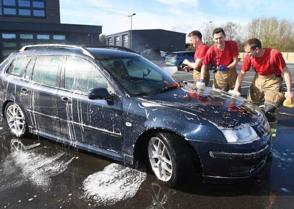 Charity car wash at Sleaford Fire Station. L-R Crew manager Colin Calam, Crew manager Marc Gardener, Firefighter James Blythe. EMN-190403-102015001